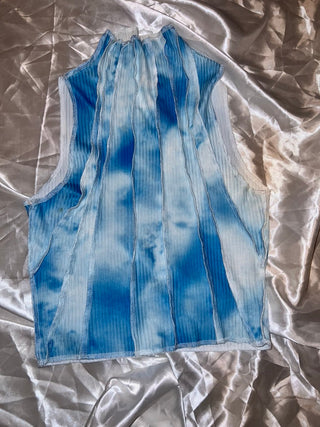 Blue and white patterned fabric on a textured silver surface