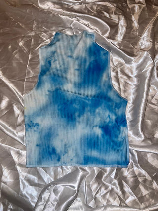 Blue abstract painting on crumpled silver paper