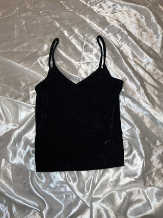 Black tank top on a textured white background
